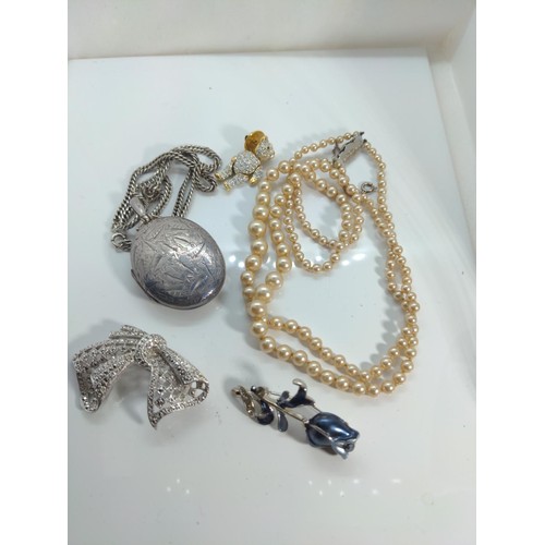 630 - Hallmarked silver locket and silver chain, silver clasped simulated pearl necklace and three novelty... 