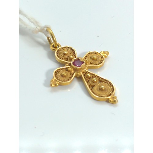 646 - 18ct gold filigree cross pendant set with a small ruby, gross weight 2 grams