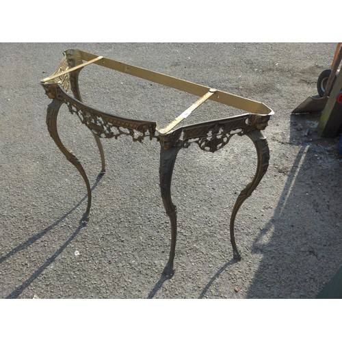 79 - Regency style brass table frame, with swag & shell decorated apron, and inset faces to support t... 