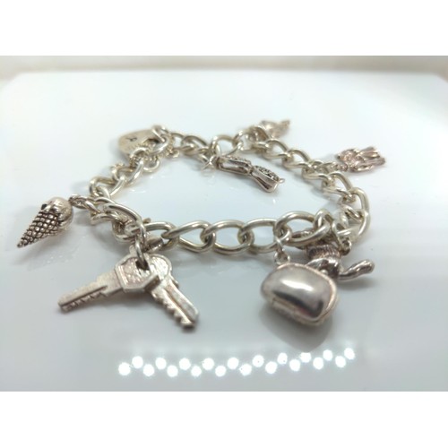 667 - Silver charm bracelet, 29.68 grams