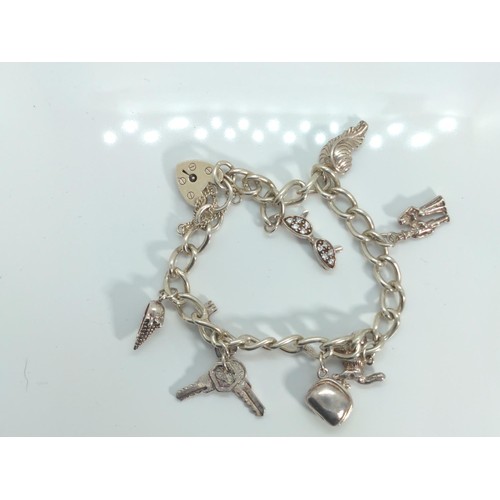 667 - Silver charm bracelet, 29.68 grams