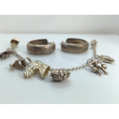 676 - Silver and white metal charm bracelet, together with a pair of white metal hoop earrings, gross weig... 