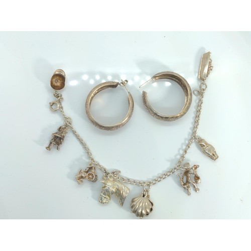 676 - Silver and white metal charm bracelet, together with a pair of white metal hoop earrings, gross weig... 