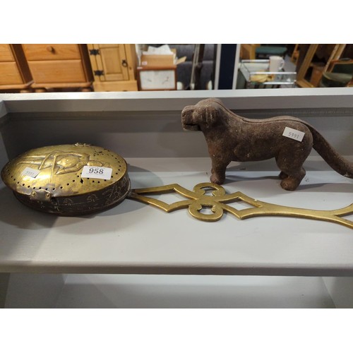 958 - Brass chestnut roaster depicting knight in armour and cast iron dog nut cracker.