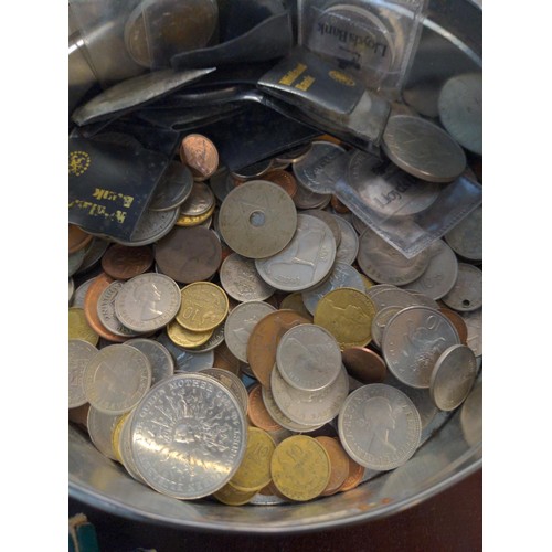 597 - Tin of British and world coins, gross weight including tin 2.09kg