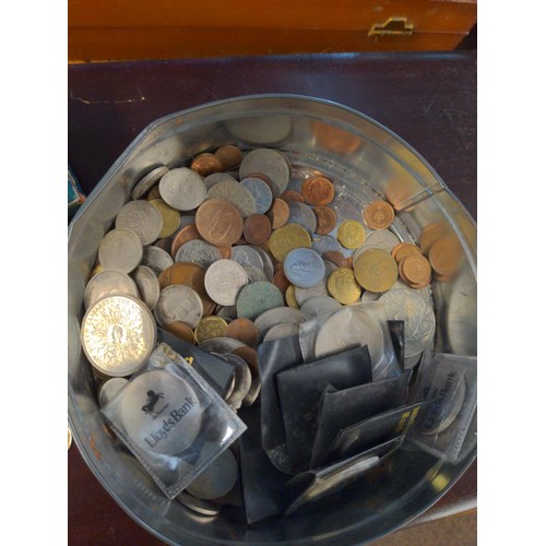 597 - Tin of British and world coins, gross weight including tin 2.09kg