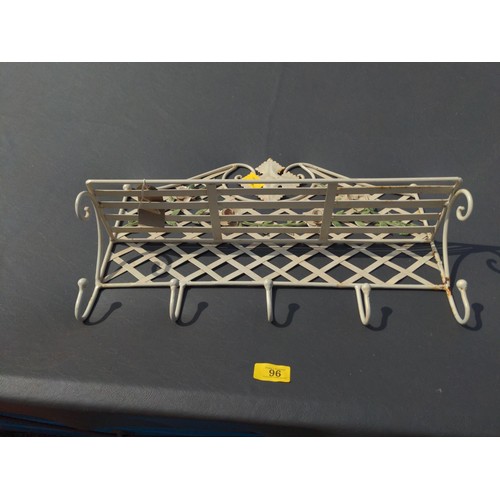 12 - Floral metal coat hanger with small shelf. W47cm