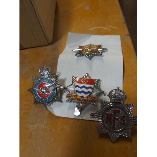 577 - British enamel fire service badges and USA cloth fire badges etc.