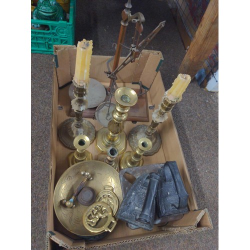 673 - Tray of metalware inc. flat irons, trivets, brass candlesticks, scales etc.