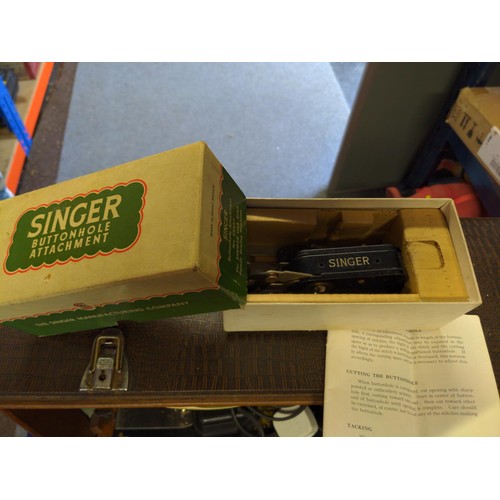 254 - Electric singer sewing machine (no plug) with handbooks and accessories in case.