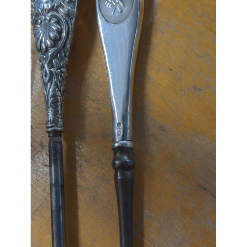 568 - Three hallmarked silver handled boot hooks and a shoe horn