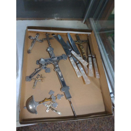 570 - Collection of crucifixes and a set of six 'Pearlcraft' stainless knives