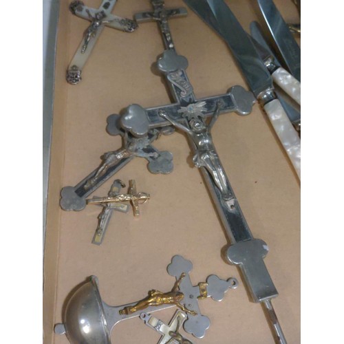 570 - Collection of crucifixes and a set of six 'Pearlcraft' stainless knives