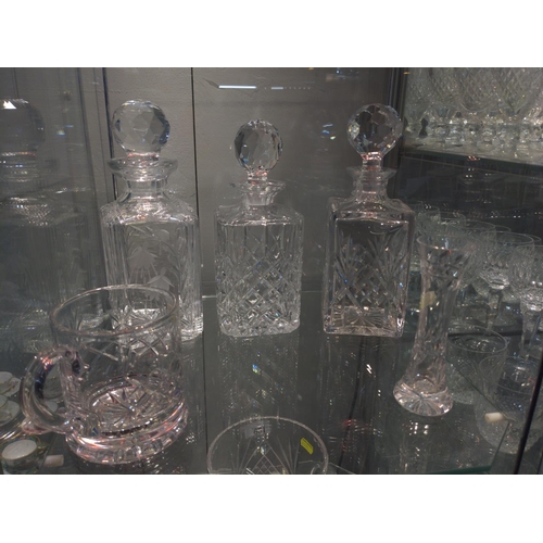 650 - Four crystal decanters, one tankard and small vase. Some Edinburgh marks.