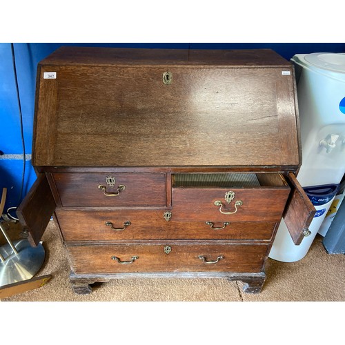 342 - Oak writing bureau with four drawers. Locks in place but no key. 