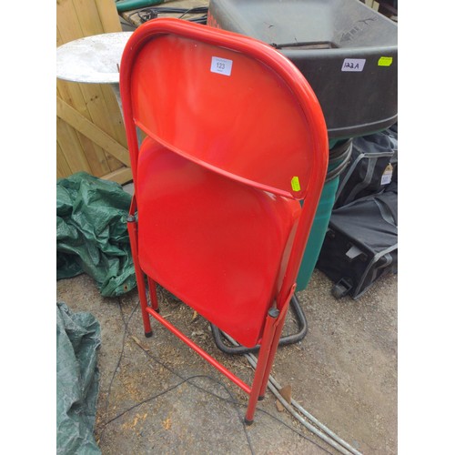 123 - Red metal folding chair.