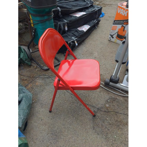 123 - Red metal folding chair.