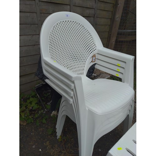 60 - 4 plastic stacking patio chairs with small table by Alibert.