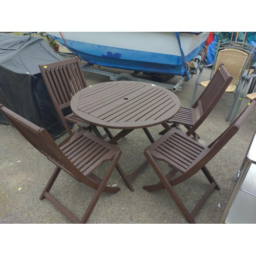 7 - Teak set of 4 folding chairs & table (D90cm). Table is wobbly, although appears undamaged.