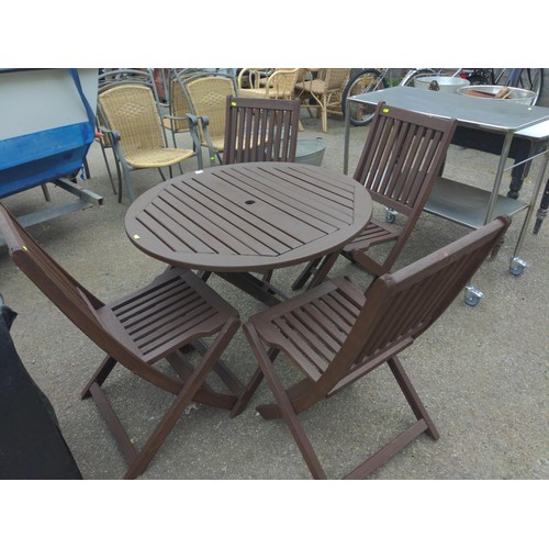 7 - Teak set of 4 folding chairs & table (D90cm). Table is wobbly, although appears undamaged.