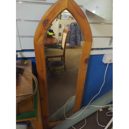 332 - Ecclesiastical style, arched  pine framed mirror. 132cm x 42cm