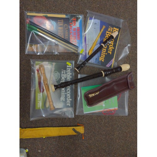 566 - 2 Aulos recorders 3 irish tin whistles plus one other recorder and relevant sheet music books