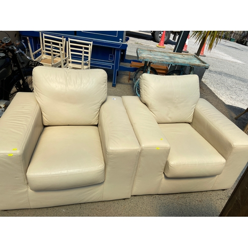 848 - Two cream leather armchairs. W102 D91 H89cm with fire regs.