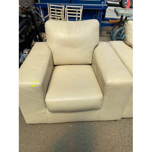 848 - Two cream leather armchairs. W102 D91 H89cm with fire regs.