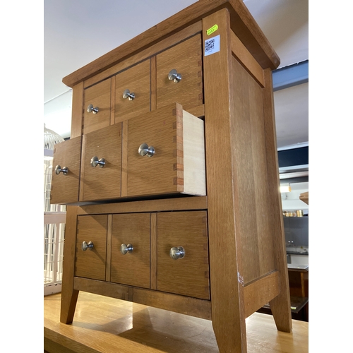 851 - Three drawer ( faux handles for 9 drawers) modern oak chest of drawers.