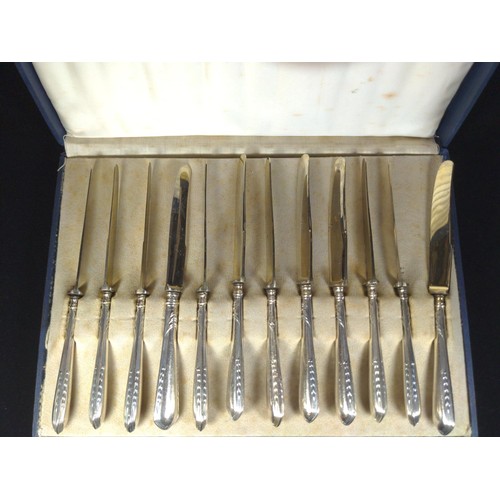 497 - Set of twelve 800 silver handled butter knives and a set of six gilt coffee spoons with sugar nips, ... 