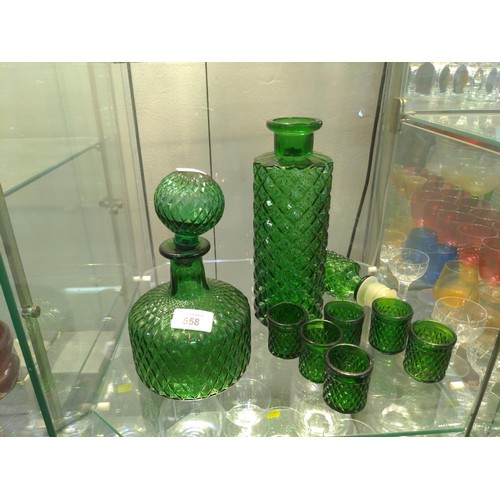 558 - Two vintage green glass decanters and six shot size glasses. H38cm