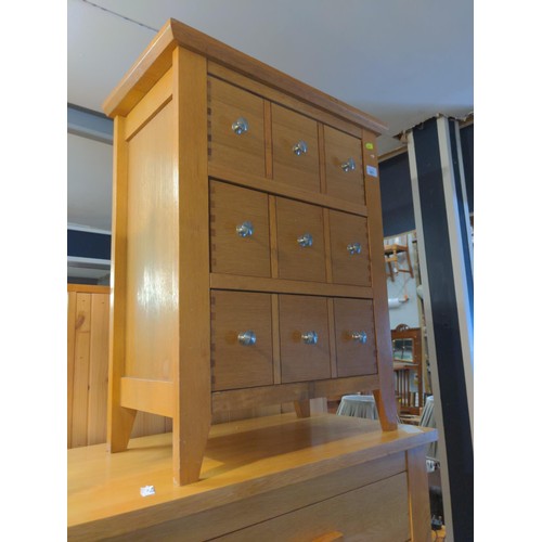 851 - Three drawer ( faux handles for 9 drawers) modern oak chest of drawers.