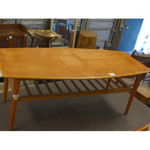 838 - Teak mid century coffee table with lower magazine rack. 120 x 54 x 48cm. Water marks to surface.