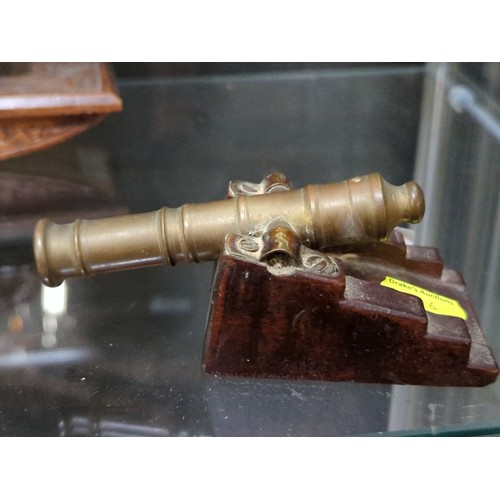 504A - Brass firing miniature canon on wooden carriage, length 13cm