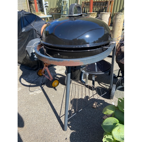 9A - Mobile BBQ with two wheels, large domed cooking area with smoking lid. Also has drip pan, griddles a... 