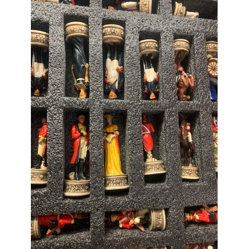 592 - Napoleonic themed chess set pieces stored in board