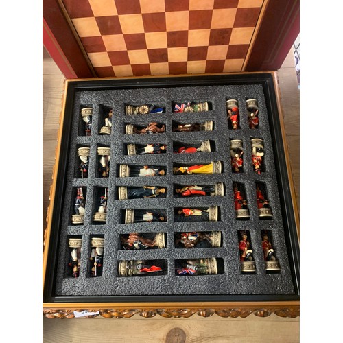 592 - Napoleonic themed chess set pieces stored in board