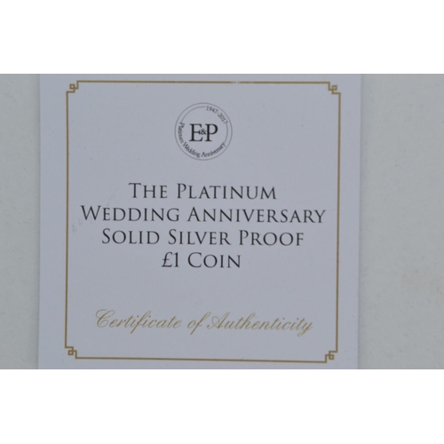 39 - Three silver coins, including: The Platinum Wedding Anniversary Solid Silver Proof £1 Coin; 20... 