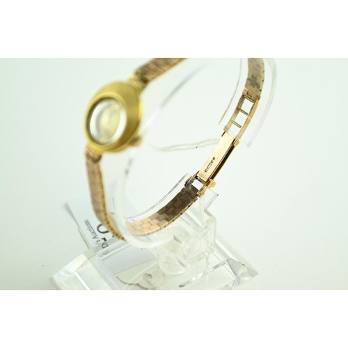 59 - Omega ladies 18ct gold watch on a 9ct strap  . Gross weight 24g. running