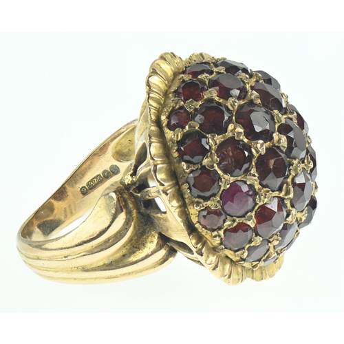 81 - 9ct gold and garnet dress ring of flower design, size N, gross weight 16.48 grams