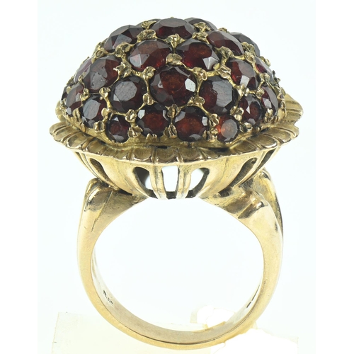 81 - 9ct gold and garnet dress ring of flower design, size N, gross weight 16.48 grams