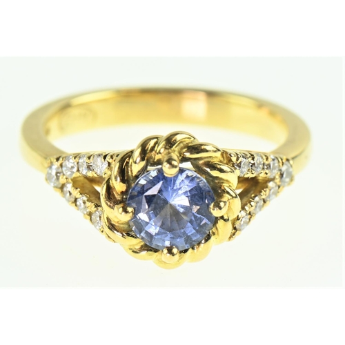 85 - Sapphire and diamond 18ct gold ring, the cornflower blue sapphire measuring 7mm diameter, flanked wi... 