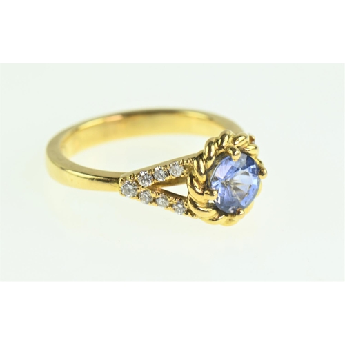 85 - Sapphire and diamond 18ct gold ring, the cornflower blue sapphire measuring 7mm diameter, flanked wi... 