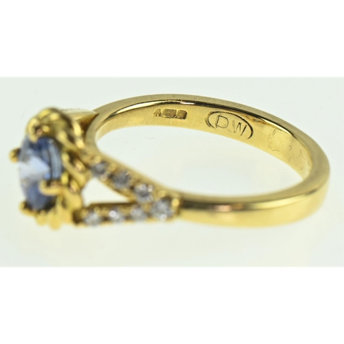 85 - Sapphire and diamond 18ct gold ring, the cornflower blue sapphire measuring 7mm diameter, flanked wi... 