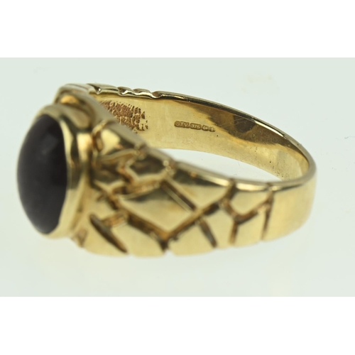 126 - 9ct gold ring with oval tigers eye stone, size O, gross weight 5.57 grams