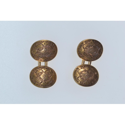 189 - Pair of 15ct gold cufflinks, hallmarked London 1928, the oval faces engraved with leaves, length of ... 