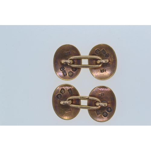 189 - Pair of 15ct gold cufflinks, hallmarked London 1928, the oval faces engraved with leaves, length of ... 