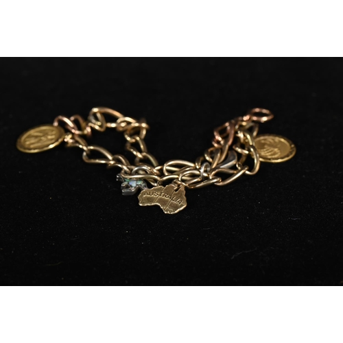 204 - Yellow metal charm bracelet with three 9ct gold charms and two silver opal set charms, yellow metal ... 