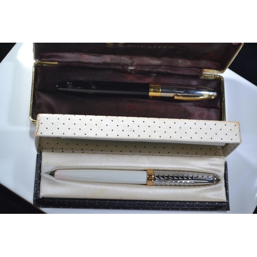 286 - Two fountain pens, Parker Sonnet metal and pearl with 18k nib and Sheaffer fountain pen with 18k nib... 