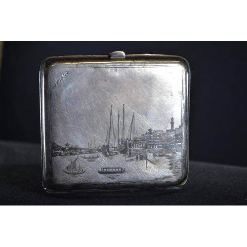 303 - Iraqi white metal and niello cigarette case, the cover decorated with a harbour scene, the base with... 